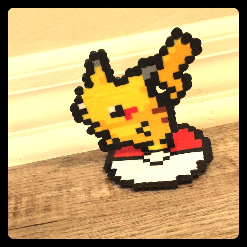 Picachu standing on a Poké Ball